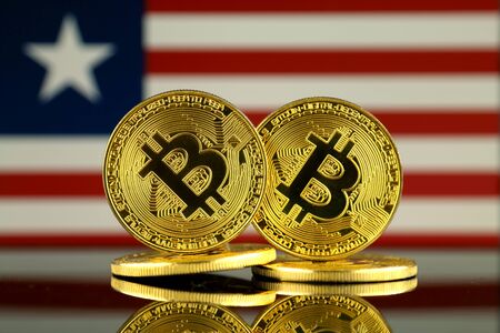 Physical version of Bitcoin and Liberia Flag. Close up.の写真素材