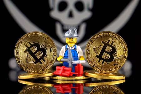 Physical version of Bitcoin (new virtual money), miner and Pirate Flag. Conceptual image for cryptocurrency mining and Blockchain Technology. Risk, safety and security.のeditorial素材