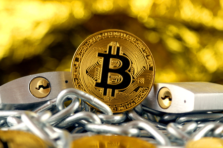Physical version of Bitcoin (new virtual money), two silver padlocks and chain. Prohibition of cryptocurrencies, regulations, restrictions or security, protection, privacy.の写真素材