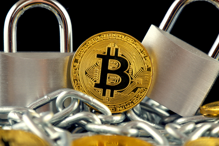 Physical version of Bitcoin (new virtual money), two silver padlocks and chain. Prohibition of cryptocurrencies, regulations, restrictions or security, protection, privacy.の写真素材