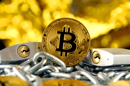 Physical version of Bitcoin (new virtual money), two silver padlocks and chain. Prohibition of cryptocurrencies, regulations, restrictions or security, protection, privacy.の写真素材