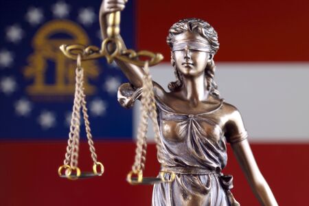 Symbol of law and justice with Georgia State Flag. Close up.の写真素材