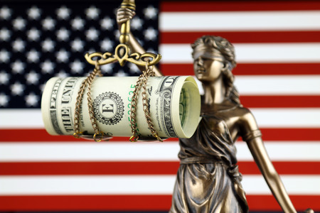 Symbol of law and justice, banknote of one dollar and United States Flag on laptop. Studio shot.の写真素材