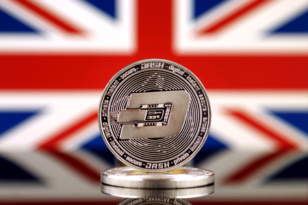 Physical version of Dash (DASH), new virtual money and United Kingdom Flag. Conceptual image for worldwide cryptocurrency and digital payment system. Studio shot.の写真素材