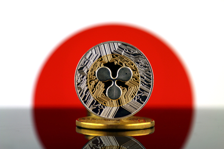 Physical version of Ripple (XRP), new virtual money and Japan Flag. Conceptual image for worldwide cryptocurrency and digital payment system. Studio shot.の写真素材