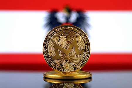 Physical version of Monero (XMR), new virtual money and Austria Flag. Conceptual image for worldwide cryptocurrency and digital payment system. Studio shot.の写真素材