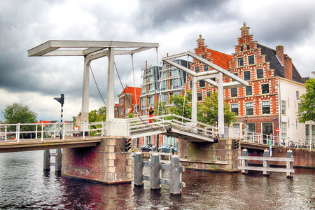 HAARLEM, NETHERLANDS - JULY 09, 2018 : Gravestenen drawbridge over Spaarne river. Typical Dutch architecture.のeditorial素材