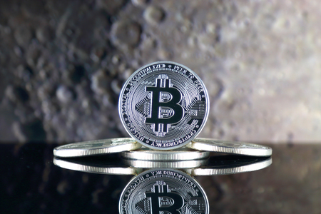 Bitcoin (BTC) and the moon. The saying TO THE MOON suggests an increase in the value of cryptocurrencies.の写真素材