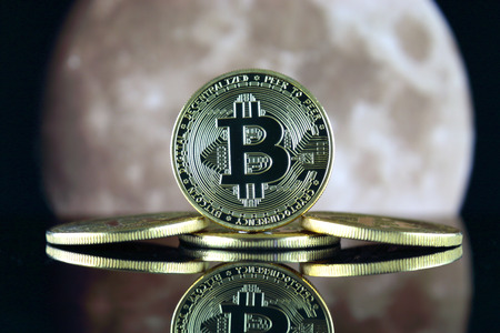 Bitcoin (BTC) and the moon. The saying TO THE MOON suggests an increase in the value of cryptocurrencies.の写真素材