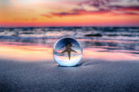 Beautiful sunset on the beach in Slowinski National Park near Leba, Poland. View through a glass,...