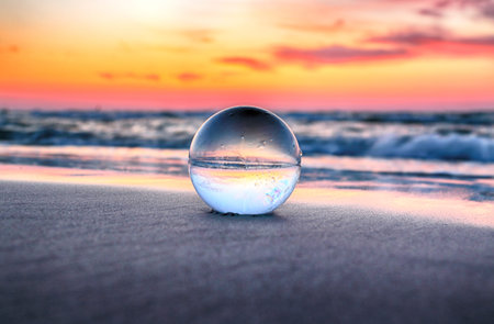 Beautiful sunset on the beach in Slowinski National Park near Leba, Poland. View through a glass,...