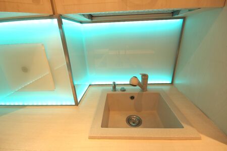 WROCLAW, POLAND - NOVEMBER 17, 2019: Modern luxury kitchen with custom made furnishings and LED RGB backlit glass. Interior of a private apartment in Wroclaw, Poland.のeditorial素材