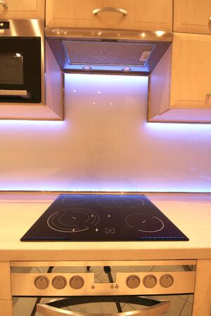 WROCLAW, POLAND - NOVEMBER 17, 2019: Modern luxury kitchen with custom made furnishings and LED RGB backlit glass. Interior of a private apartment in Wroclaw, Poland.のeditorial素材