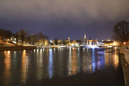 WROCLAW, POLAND - DECEMBER 15, 2019: The Oder (Odra) River at night. Cathedral Island (Ostrow Tumski) is the oldest part of the city, Wroclaw, Poland, Europe.のeditorial素材