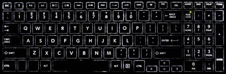 Close-up of a black laptop keyboard with LED backlit keyboard buttons.の写真素材