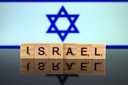 Israel Flag and country name made of small wooden letters. Studio shot.の写真素材