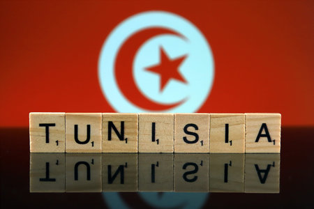 Tunisia Flag and country name made of small wooden letters. Studio shot.