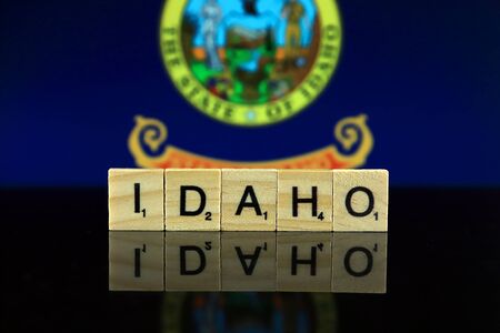 Idaho State Flag and state name made of small wooden letters. Studio shot.の写真素材