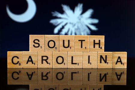 South Carolina State Flag and state name made of small wooden letters. Studio shot.の写真素材