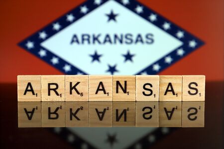 Arkansas State Flag and state name made of small wooden letters. Studio shot.の写真素材