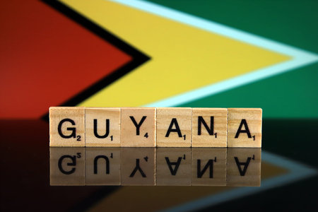 Guyana Flag and country name made of small wooden letters. Studio shot.の写真素材