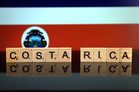 Costa Rica Flag and country name made of small wooden letters. Studio shot.の写真素材