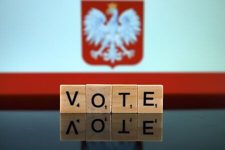 Poland Flag and word VOTE made of small wooden letters. Studio shot.の写真素材