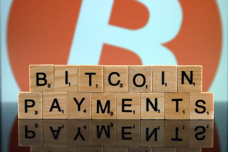 WROCLAW, POLAND - FEBRUARY 04, 2020: Words BITCOIN PAYMENTS made of small wooden letters. Conceptual...