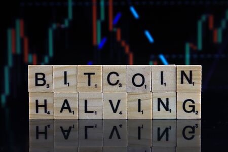 WROCLAW, POLAND - FEBRUARY 04, 2020: Words BITCOIN HALVING made of small wooden letters. Every 4 years the reward granted to Bitcoin miners for adding a block to the blockchain is cut in half.のeditorial素材