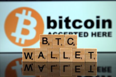 WROCLAW, POLAND - FEBRUARY 04, 2020: Words BTC WALLET made of small wooden letters. Bitcoin (BTC) wallets can either be digital apps or be hardware based.のeditorial素材
