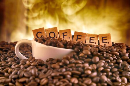 WROCLAW, POLAND - FEBRUARY 05, 2020: White porcelain cup in coffee grains, and word COFFEE made of small wooden letters. Conceptual image for lovers of delicious coffee.のeditorial素材