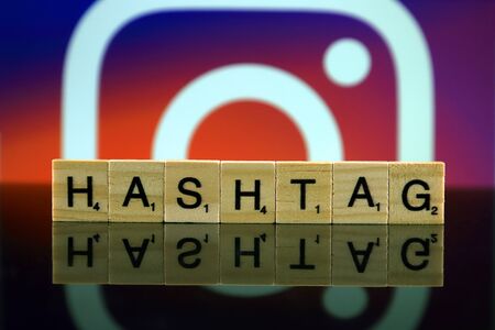 WROCLAW, POLAND - FEBRUARY 12, 2020: Word HASHTAG made of small wooden letters, and INSTAGRAM logo in the background. Studio shot.のeditorial素材