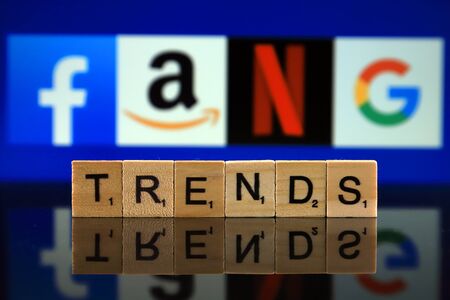 WROCLAW, POLAND - FEBRUARY 12, 2020: Word TRENDS made of small wooden letters, and FACEBOOK, AMAZON, NETFLIX, GOOGLE logos in the background. Studio shot.のeditorial素材