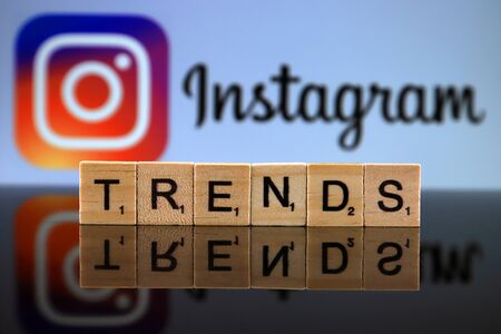 WROCLAW, POLAND - FEBRUARY 12, 2020: Word TRENDS made of small wooden letters, and INSTAGRAM logo in the background. Studio shot.のeditorial素材