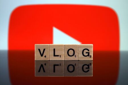 WROCLAW, POLAND - FEBRUARY 12, 2020: Word VLOG made of small wooden letters, and YOUTUBE logo in the background. Studio shot.のeditorial素材