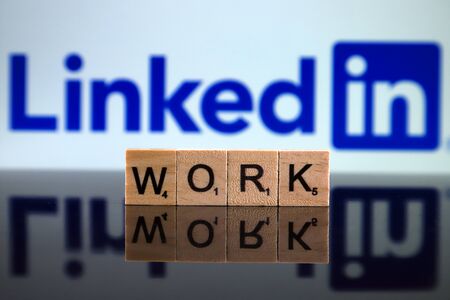 WROCLAW, POLAND - FEBRUARY 12, 2020: Word WORK made of small wooden letters, and LINKEDIN logo in the background. Studio shot.のeditorial素材