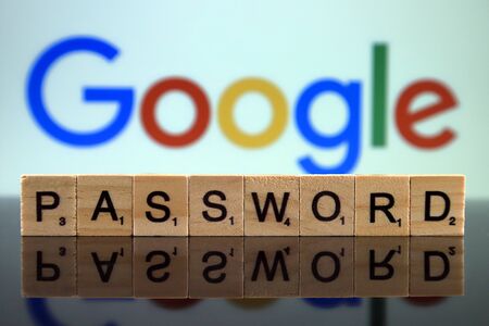 WROCLAW, POLAND - FEBRUARY 12, 2020: Word PASSWORD made of small wooden letters, and GOOGLE logo in the background. Studio shot.のeditorial素材