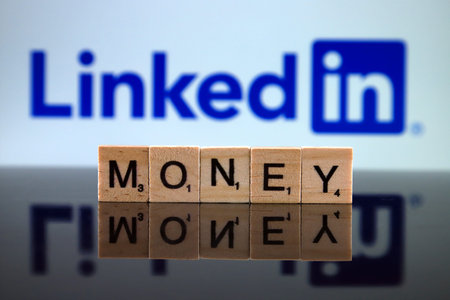 WROCLAW, POLAND - FEBRUARY 12, 2020: Word MONEY made of small wooden letters, and LINKEDIN logo in...