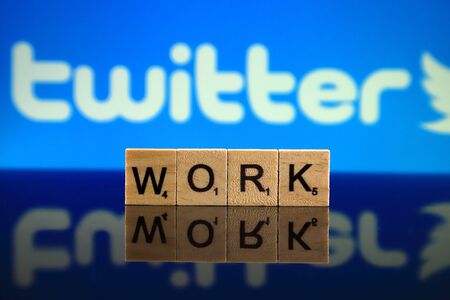 WROCLAW, POLAND - FEBRUARY 12, 2020: Word WORK made of small wooden letters, and TWITTER logo in the background. Studio shot.のeditorial素材
