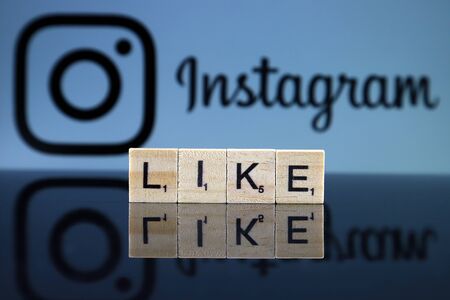 WROCLAW, POLAND - FEBRUARY 12, 2020: Word LIKE made of small wooden letters, and INSTAGRAM logo in the background. Studio shot.のeditorial素材