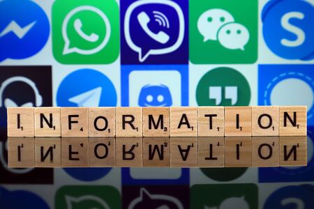 WROCLAW, POLAND - FEBRUARY 19, 2020: Word INFORMATION made of wooden letters, and MESSENGER, WHATSAPP, VIBER, WECHAT, SKYPE, TEAMSPEAK, TELEGRAM, DISCORD, GOOGLE HANGOUTS, SIGNAL logos in the background.のeditorial素材