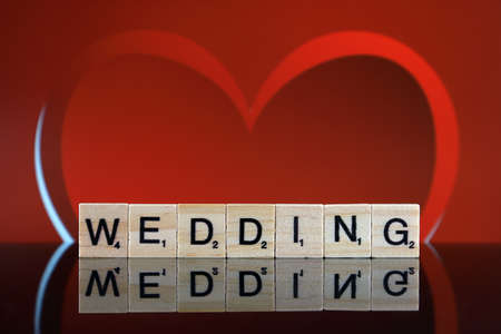 WROCLAW, POLAND - FEBRUARY 28, 2020: The word WEDDING made of scrabble letters and one heart in the background. Studio shot.のeditorial素材