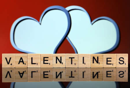 WROCLAW, POLAND - FEBRUARY 28, 2020: The word VALENTINES made of scrabble letters and two hearts in the background. Studio shot.のeditorial素材