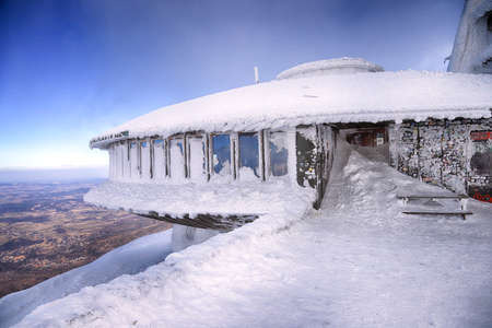 KARPACZ, POLAND - MARCH 08, 2020: A disc-shaped observatory with a weather station and restaurant was built in 1974, located on the peak of Sniezka mountain (1602 m.), Giant Mountains, Poland, Europe.のeditorial素材