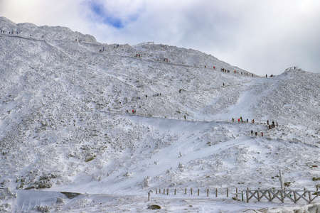KARPACZ, POLAND - MARCH 08, 2020: Tourist trail to Sniezka (mountain on the border between the Czech Republic and Poland). Winter landscape. Giant Mountains, Poland, Europe.のeditorial素材