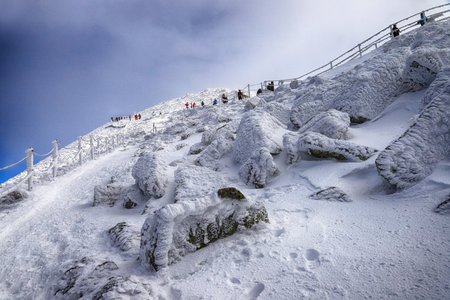 KARPACZ, POLAND - MARCH 08, 2020: Tourist trail to Sniezka (mountain on the border between the Czech...