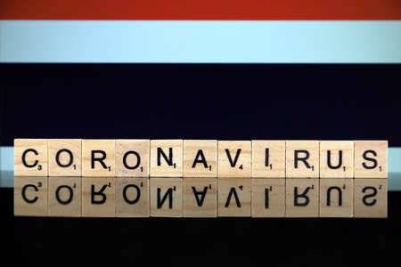 WROCLAW, POLAND - MARCH 28, 2020: Word CORONAVIRUS made of wooden letters, and Thailand Flag in the background. Coronavirus (COVID-19) global disease 2020.のeditorial素材