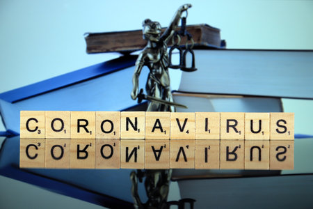 WROCLAW, POLAND - MARCH 30, 2020: The word CORONAVIRUS made of wooden letters, and symbol of law and justice in the background. Coronavirus (COVID-19) global disease 2020.のeditorial素材