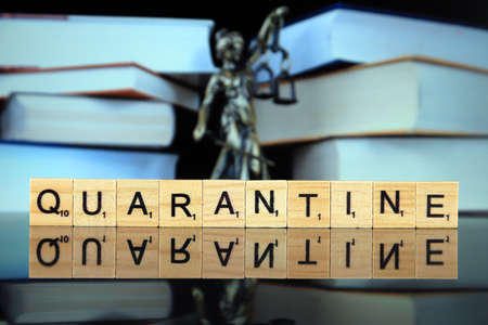 WROCLAW, POLAND - MARCH 30, 2020: The word QUARANTINE made of wooden letters, and symbol of law and justice in the background. Coronavirus (COVID-19) global disease 2020.のeditorial素材