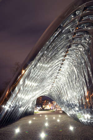 WROCLAW, POLAND - MARCH 10, 2020: Night view of the NAWA sculpture designed by Oskar Zieta, erected on Daliowa Island. Due to polished steel surface NAWA reflects its surroundings.のeditorial素材